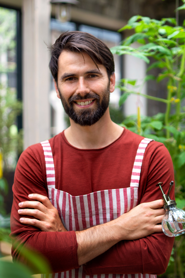 portrait-of-man-gardener-standing-in-greenhouse-l-2021-08-28-20-06-44-utc.jpg