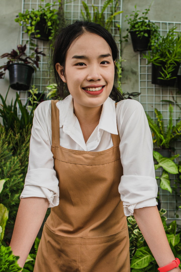 young-gardener-woman-stand-with-smile-at-greenhous-2021-10-26-03-22-28-utc.jpg